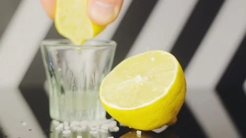Lemon Half With Another Half Squeezing Juice From It In Small Glass Stock-Footage 111977994