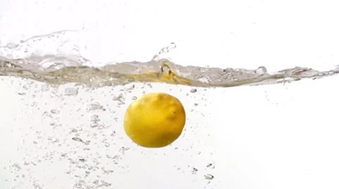 Lemon half sliced lime fruits falling into water white slow motion HD video Stock Footage 68458495