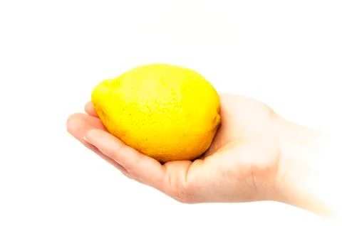 Lemon in a hand Stock Photos
