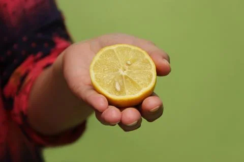 Lemon in hand Stock Photos
