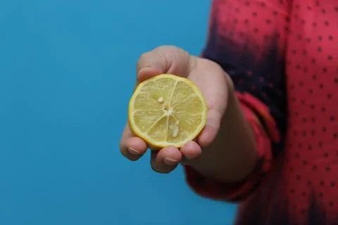 Lemon in hand Stock Photos