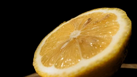 Lemon isolated on a black background. Citrus fruit. Fresh and Ripe halved lemon Video stock 115100534