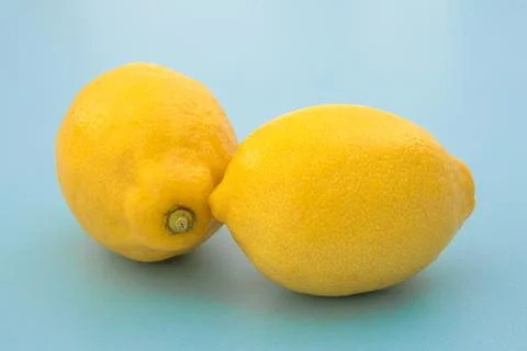 Lemon isolated in close up on a blue background Stock Photos