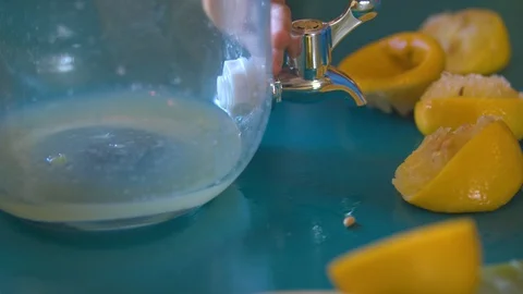 Lemon Juice Being Squeezed into a Jar to Make Lemonade Stock Footage 94395555