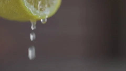 Lemon juice dripping out of a Lemon half Closeup Stock Footage 99166053