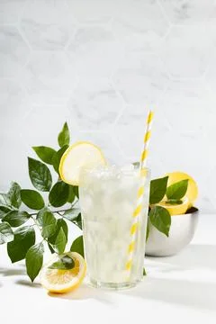 Lemon juice in soft light elegant white kitchen with green leaves in sunny da Stock Photos