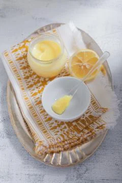 Lemon kurd with a spoon served on a table Stock Photos