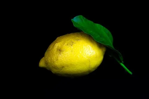 Lemon with leaf isolated on a black background Stock Photos