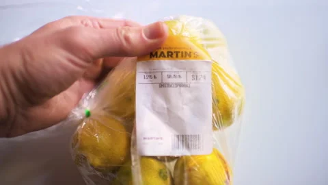 Lemon lemons in bag raw whole fruit hand holding macro closeup Stock Footage 330198627