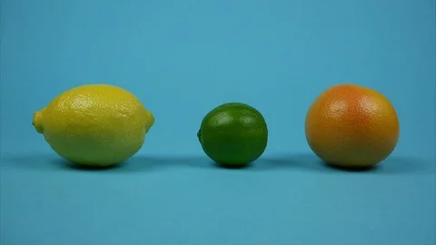 Lemon, lime and grapefruit rotating on blue background. Citrus fruits line Stock Footage 121059015