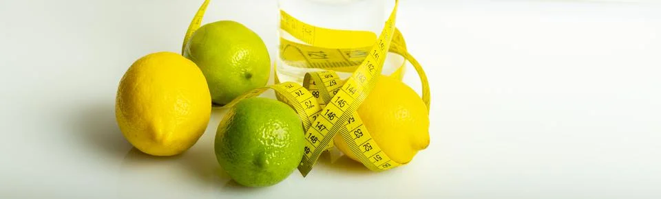 Lemon with lime on the white surface of the table with a tape measure for mea Stock Photos