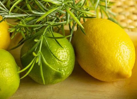 Lemon with lime on the wooden surface of the table Stock Photos
