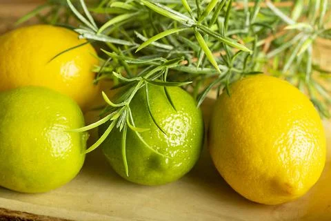 Lemon with lime on the wooden surface of the table Stock Photos