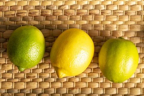 Lemon with lime on the wooden surface of the table Stock Photos