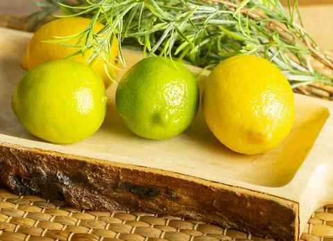 Lemon with lime on the wooden surface of the table Stock Photos