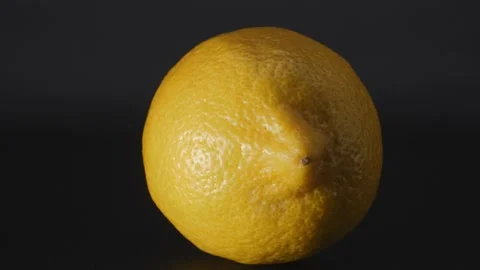 Lemon is lying on a rotating table. Stock Footage 148784172