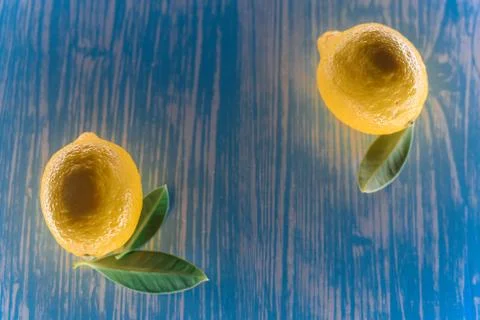 Lemon lying on a wooden table Stock Photos