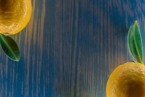 Lemon lying on a wooden table Stock Photos