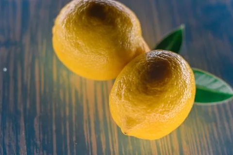 Lemon lying on a wooden table Stock Photos