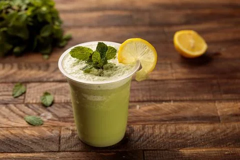 Lemon mint juice with lime slice and mint leaves served in glass side view on Stock Photos