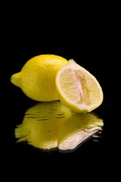 Lemon on mirror Stock Photos