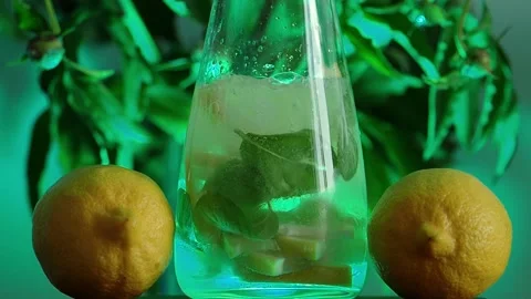 Lemon mohito in green lights Stock Footage