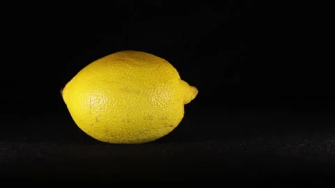 Lemon moves on a black background Stockbeeldmateriaal 144078987