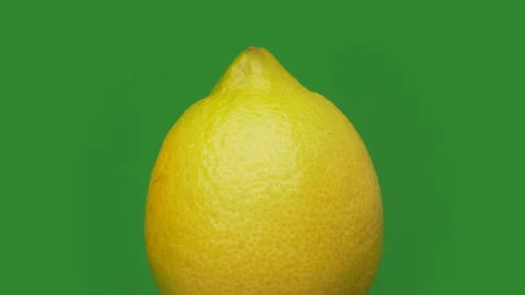 Lemon - Moving Lemon Fruit on Green Background  Stock Footage 157597758