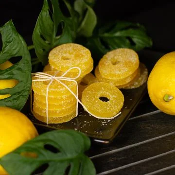 Lemon, orange and grapefruit slices in sugar isolated on a wooden background Stock Photos