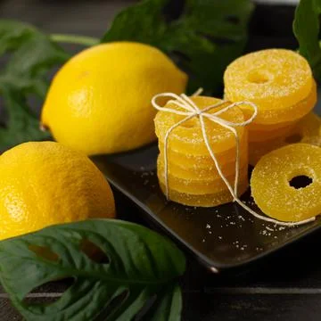 Lemon, orange and grapefruit slices in sugar isolated on a wooden background Stock Photos
