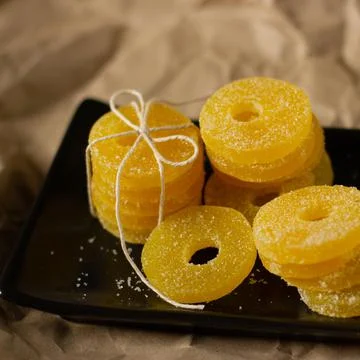 Lemon, orange and grapefruit slices in sugar isolated on a wooden background Stock Photos