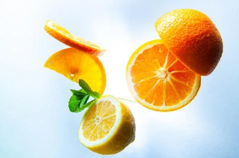 Lemon, orange and mint on a light background top view and close up 库存照片