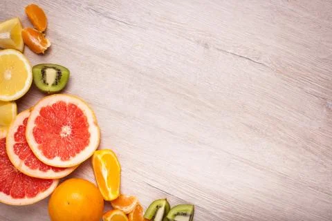 Lemon, orange, kiwi, grapefruit, mandarin on a wooden surface. arrangement .. Stock Photos