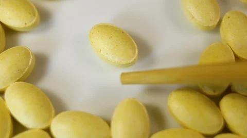 Lemon oval pressed tablets without a shell close-up, one tablet is pushed and it Stock Footage 144855377