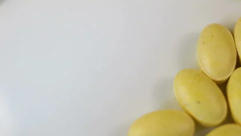 Lemon oval pressed vitamins without a shell are shifted to the side, one tablet Stock Footage 144855303