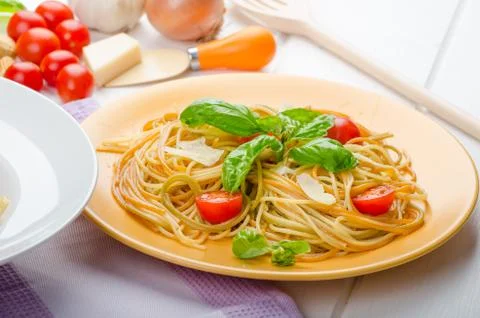 Lemon pasta with cherry tomatoes, basil and nuts Stock Photos