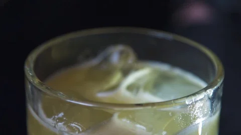 Lemon peel and chocolate bits dropped in drink Stock Footage 90123492