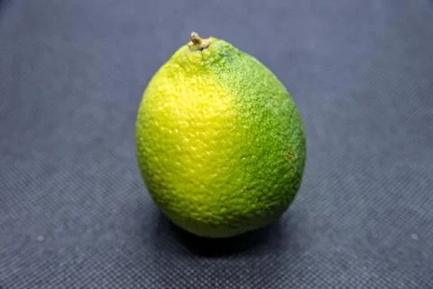 Lemon with peel on black background Stock Photos