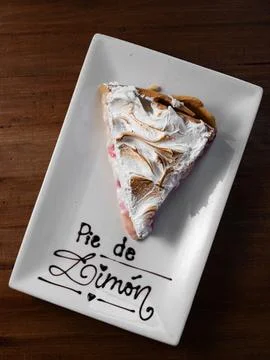 Lemon pie slice rests on a white plate 库存照片