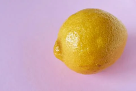 Lemon on a pink background, close-up, copy space Stock Photos