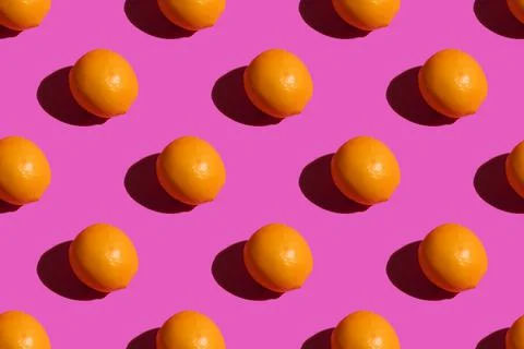 Lemon on a pink background. Lemon pattern on a pink background. Hard shadows Stock Photos