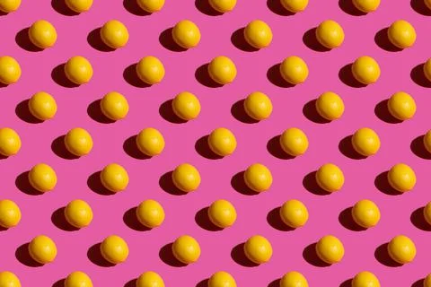 Lemon on a pink background. Lemon pattern on a pink background. Hard shadows Stock Photos
