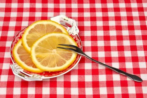 Lemon on a plate with a fork Stock Photos