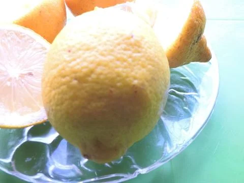 Lemon on a plate. Lime on the table. Vitamins. Proper nutrition Stock Photos