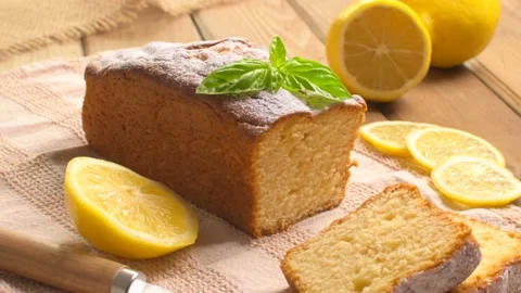 Lemon pound cake on rustic wooden background with lemon and mint. Stock Footage 159339535