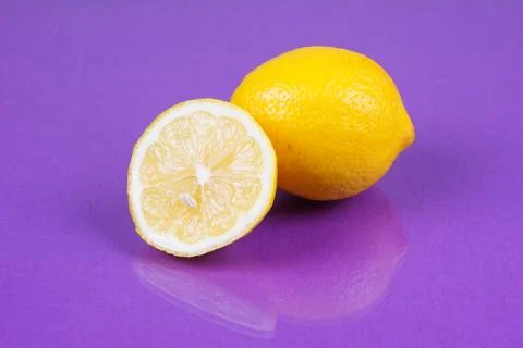 Lemon on purple background Stock Photos
