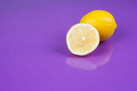 Lemon on purple background Stock Photos