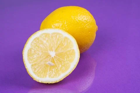 Lemon on purple background Stock Photos