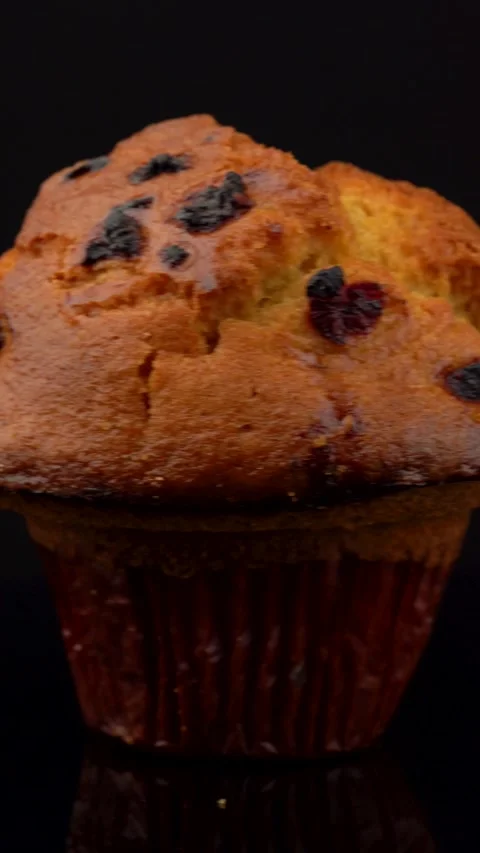 Lemon Raspberry Muffin Rotating on Dark Background Under Studio Lights Stock Footage 330518084