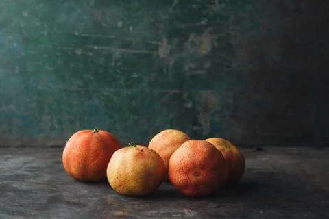 Lemon with rosy pulp on rustic background Stock Photos